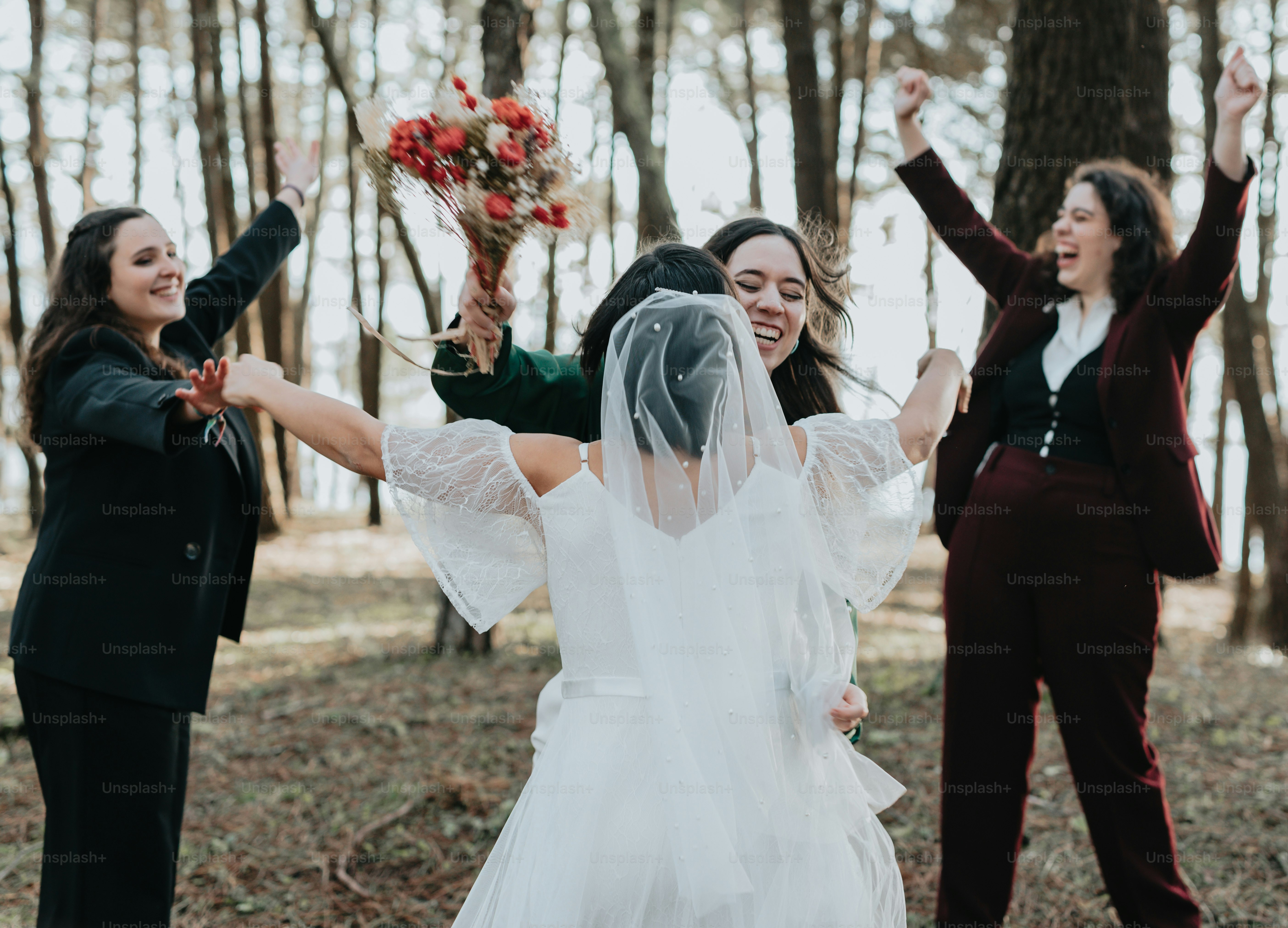 A group of women standing next to each other in a forest photo ...