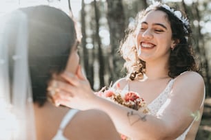 a woman in a wedding dress smiles at another woman