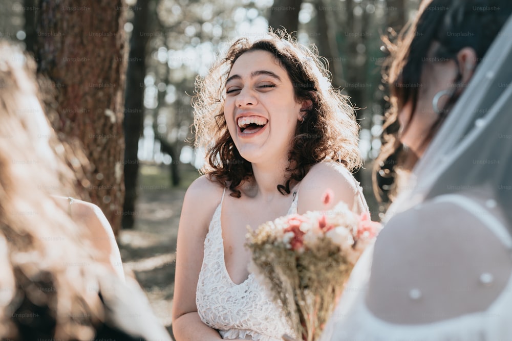 a woman in a wedding dress laughing at another woman