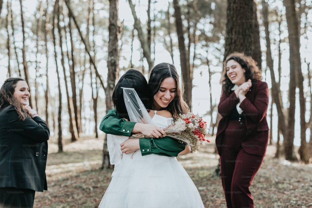 two women hugging each other in the woods