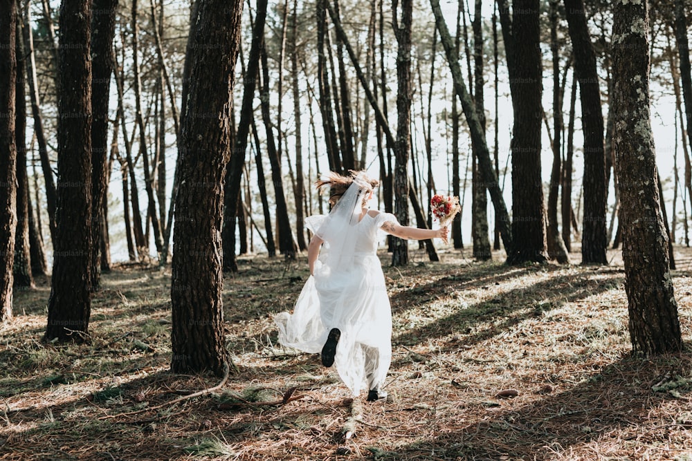 uma mulher em um vestido branco andando através de uma floresta