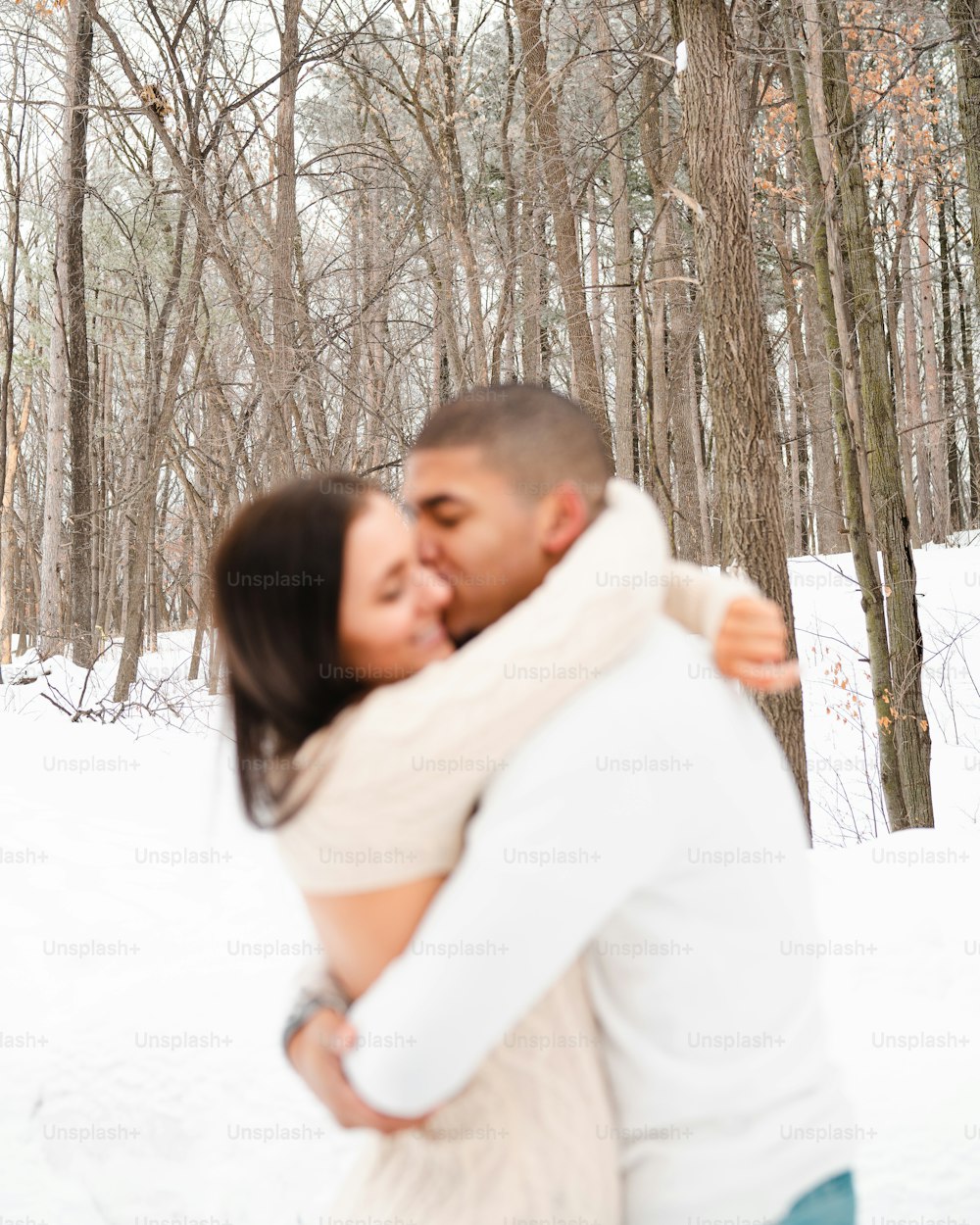 a man and a woman hugging in the snow