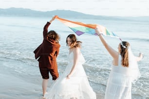 a group of people standing on top of a beach