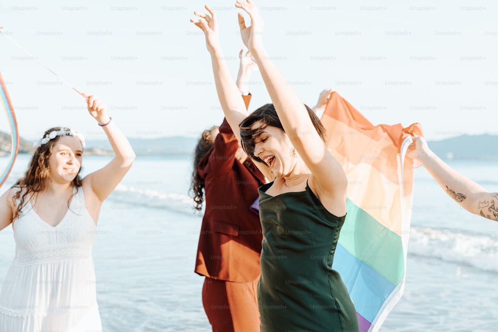 a group of women standing next to each other on a beach