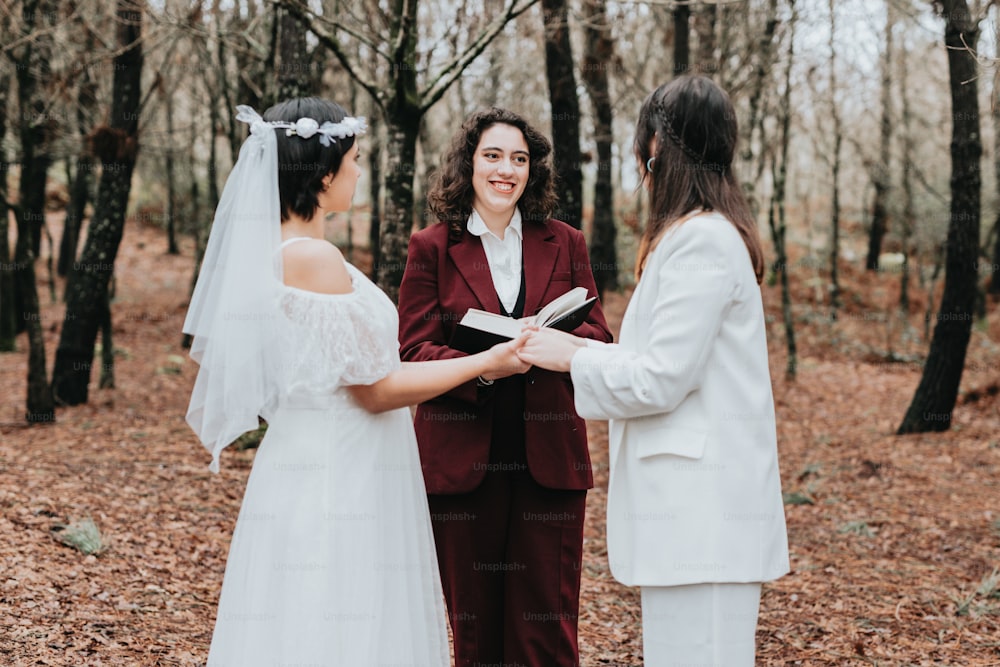a bride and groom exchanging vows in the woods