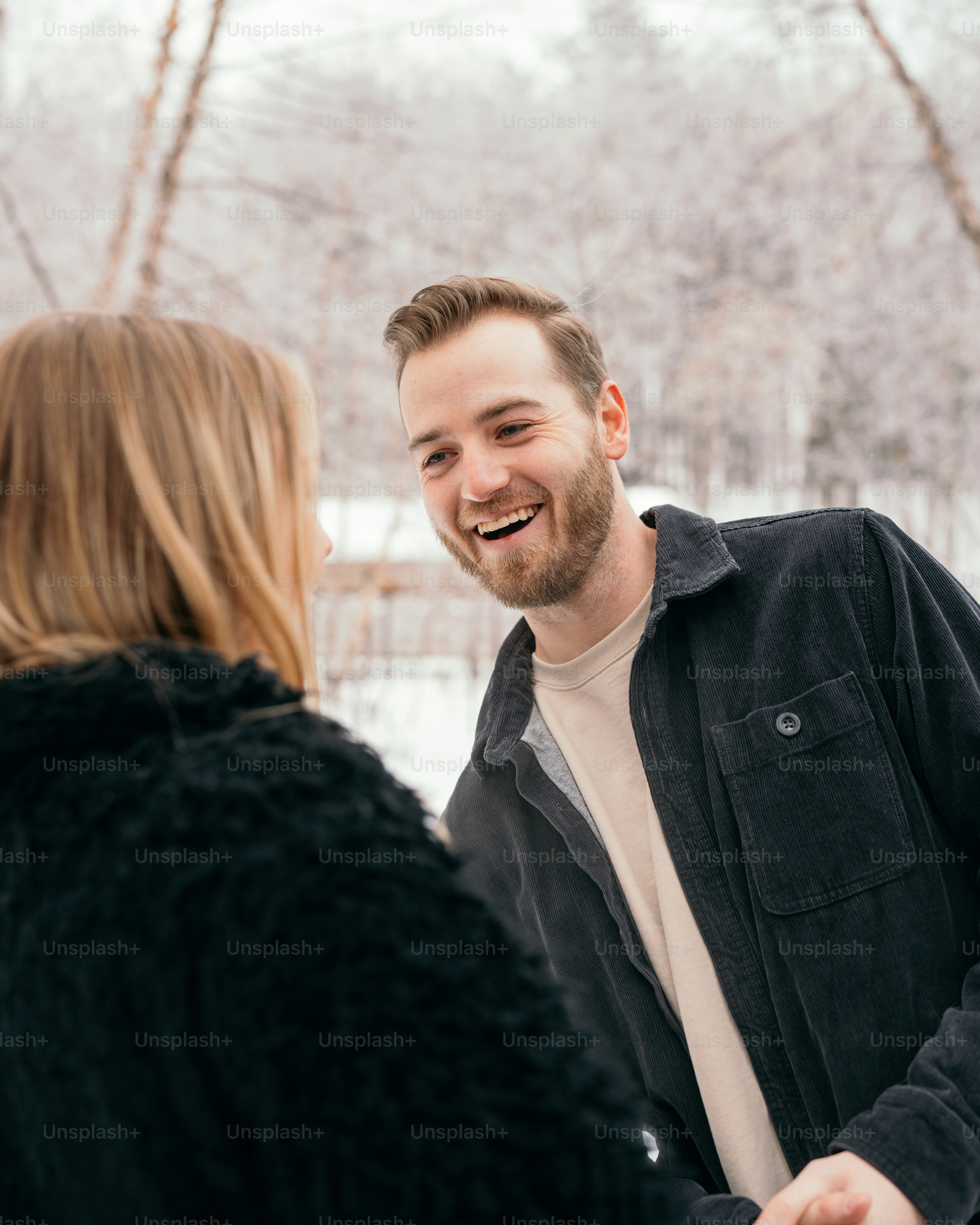 a man and a woman standing in the snow