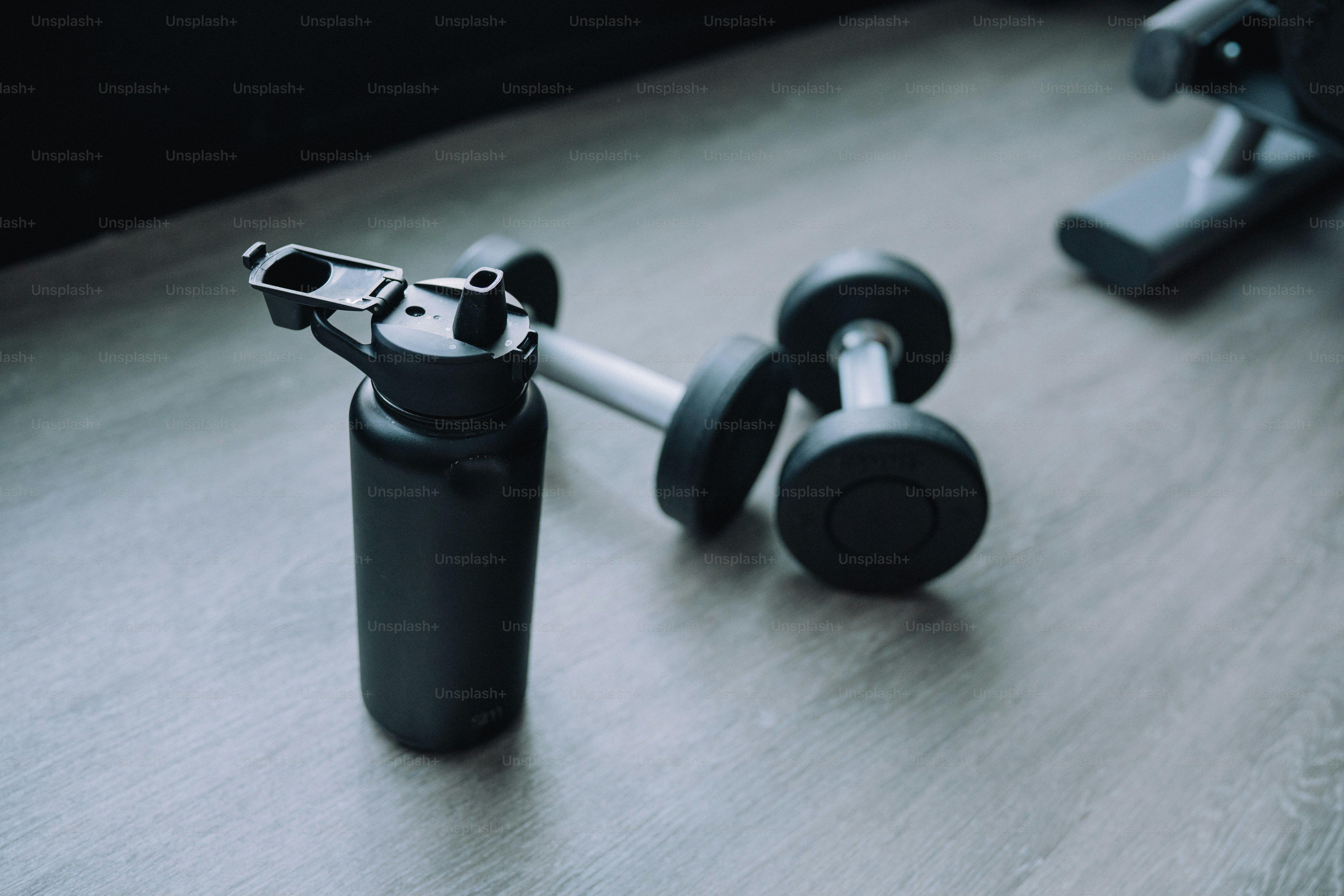 a black bottle with a handle on a table