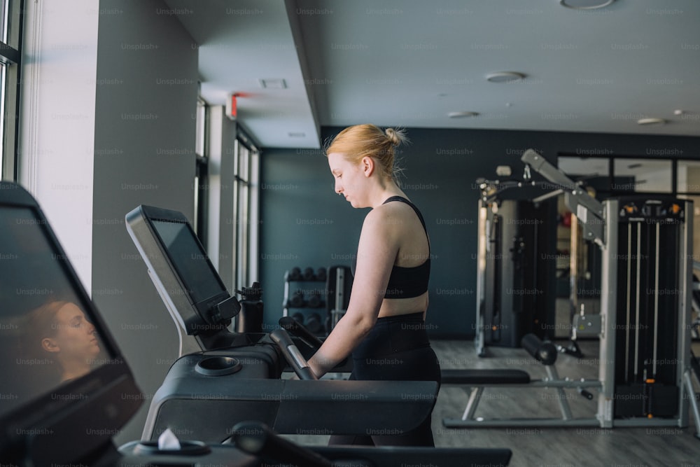 a woman on a treadmill in a gym