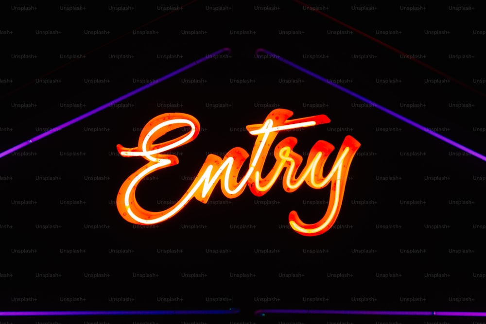 a neon sign that says entry in a dark room