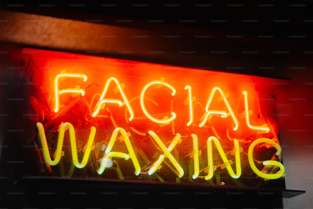 a neon sign that says facial waxing