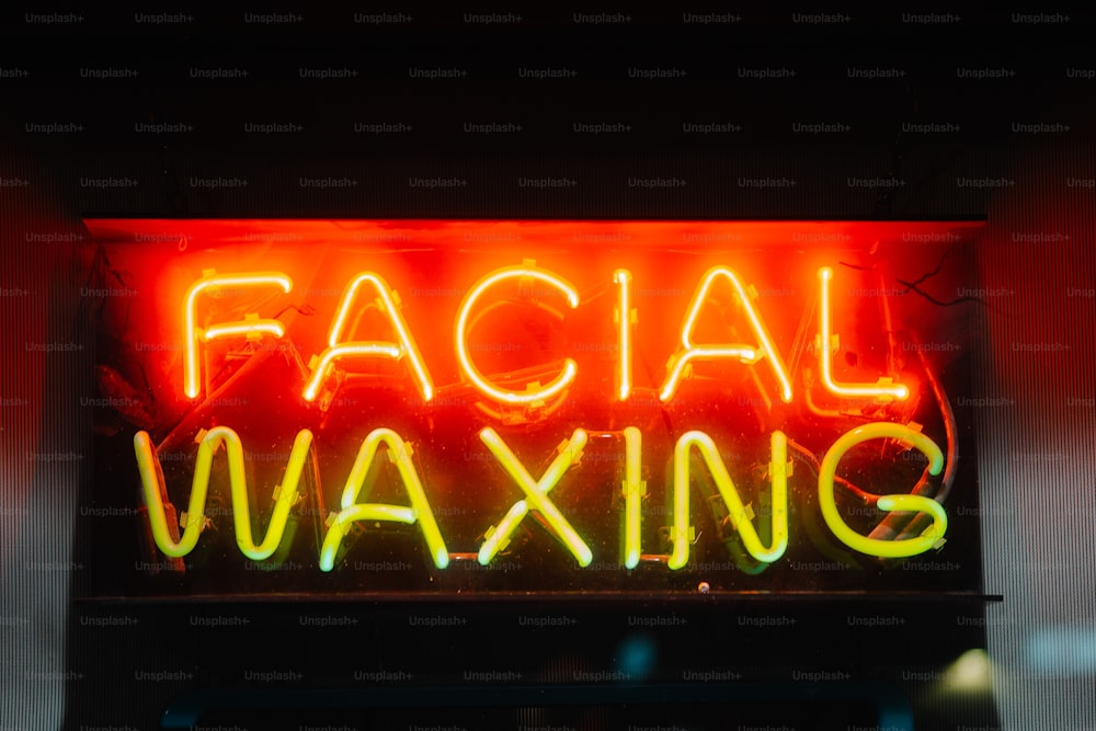a neon sign that says facial waxing