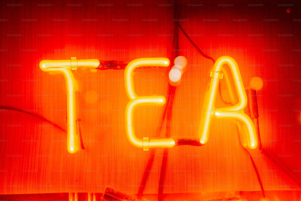 a neon sign that says tea on it