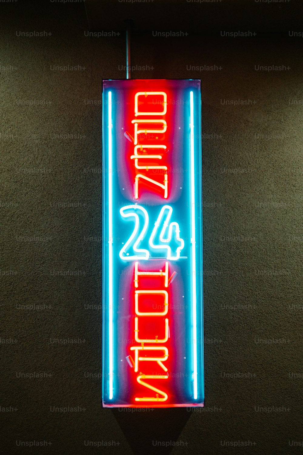 a neon sign hanging from the side of a wall