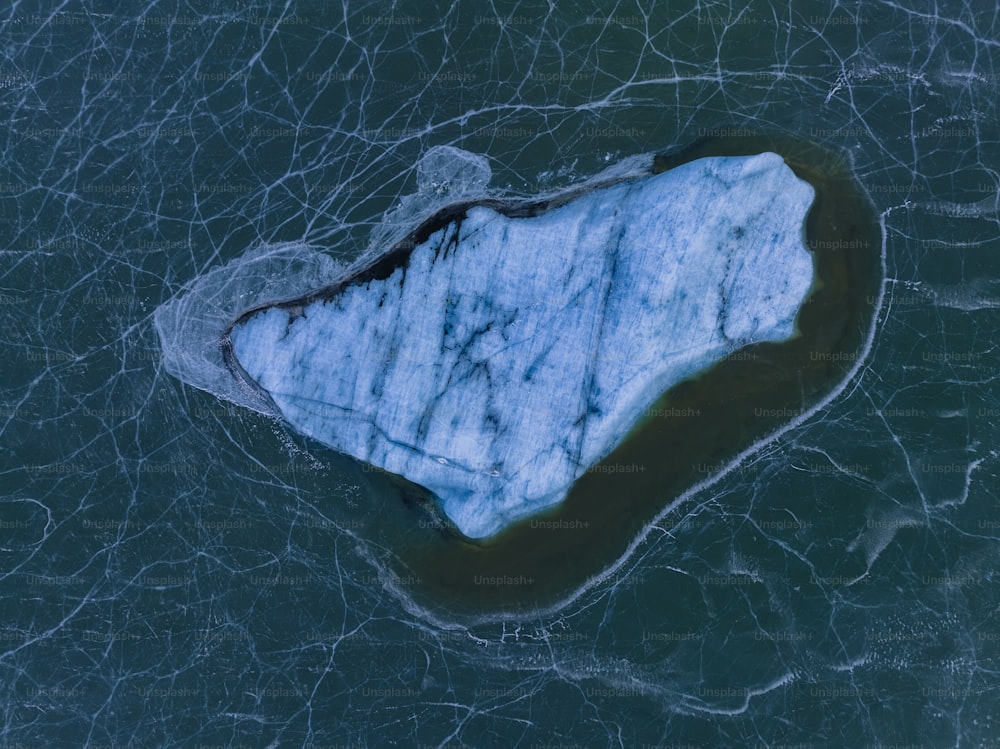 an aerial view of an iceberg in the water