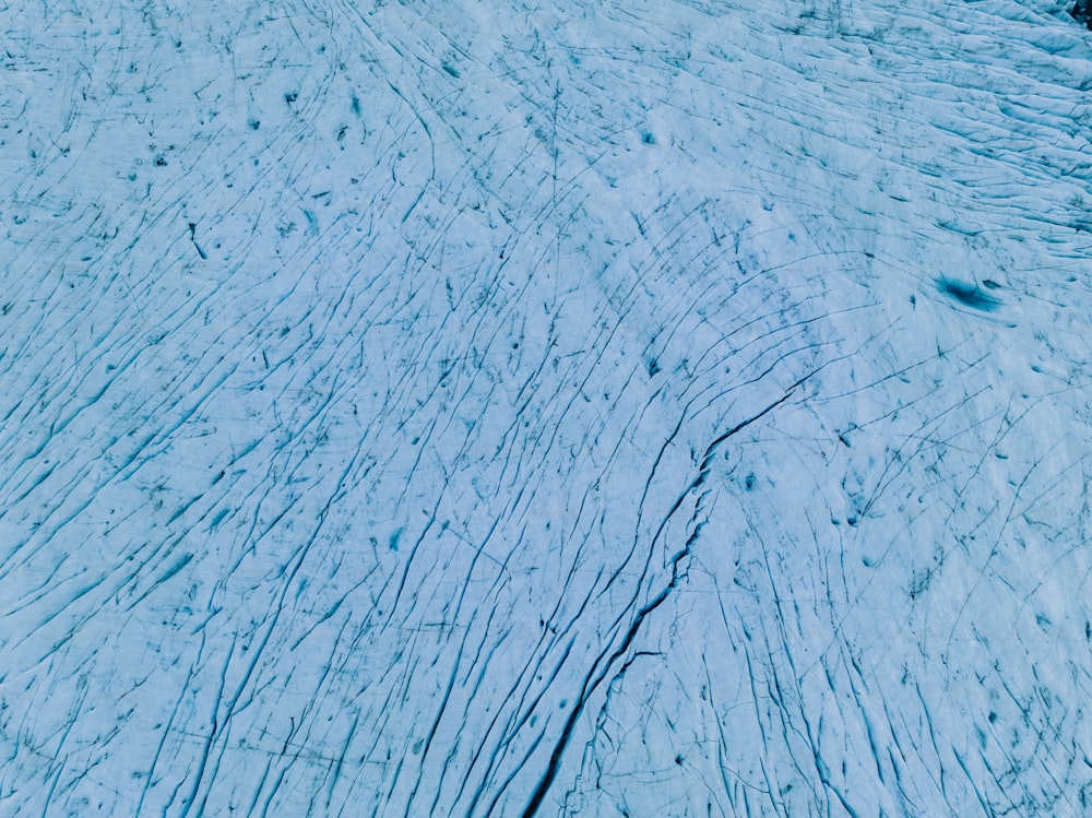 a snow covered slope with tracks in the snow