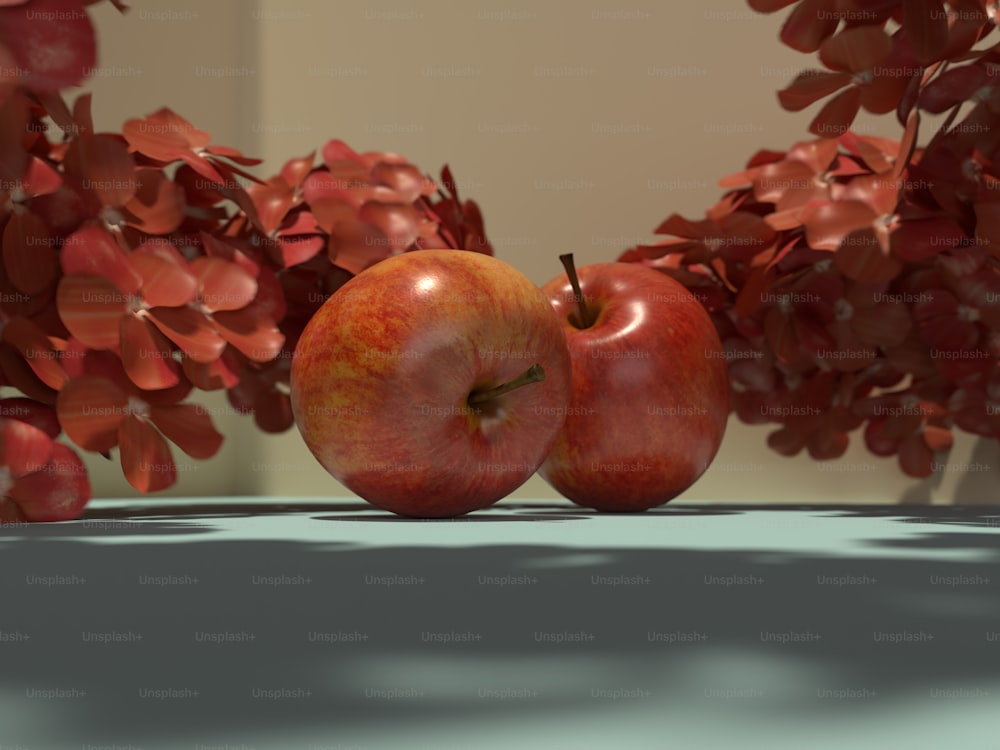 duas maçãs sentadas em uma mesa ao lado de uma planta