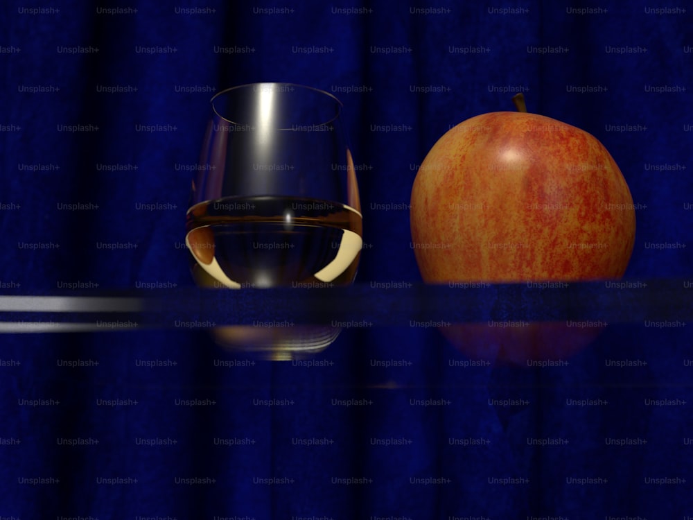 Una copa de vino y una manzana sobre una mesa