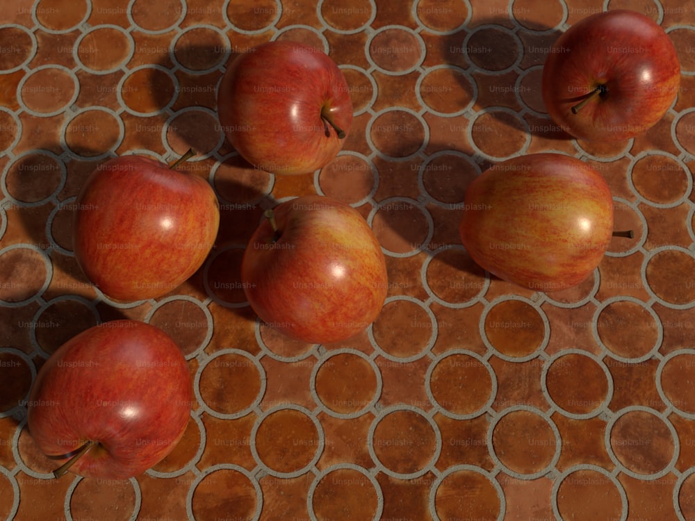 Un gruppo di mele sedute sopra un pavimento piastrellato