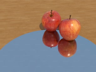 duas maçãs vermelhas sentadas em cima de uma mesa