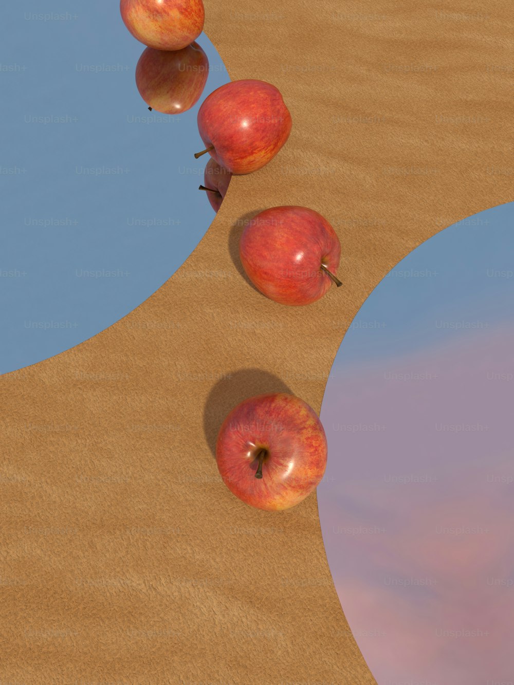 a group of apples sitting on top of a sandy beach