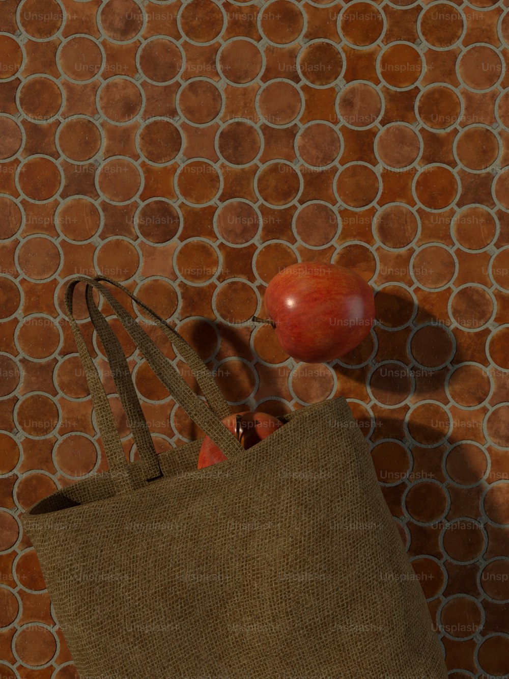 a brown bag with a red apple on top of it