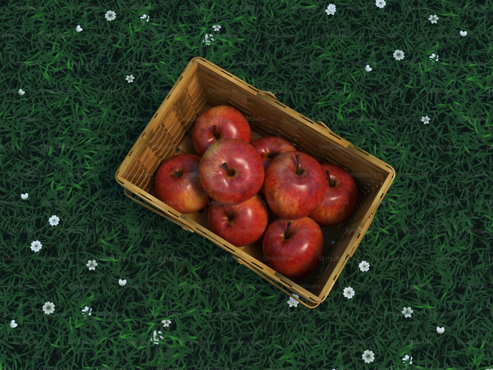 a wooden box filled with red apples on top of a green field