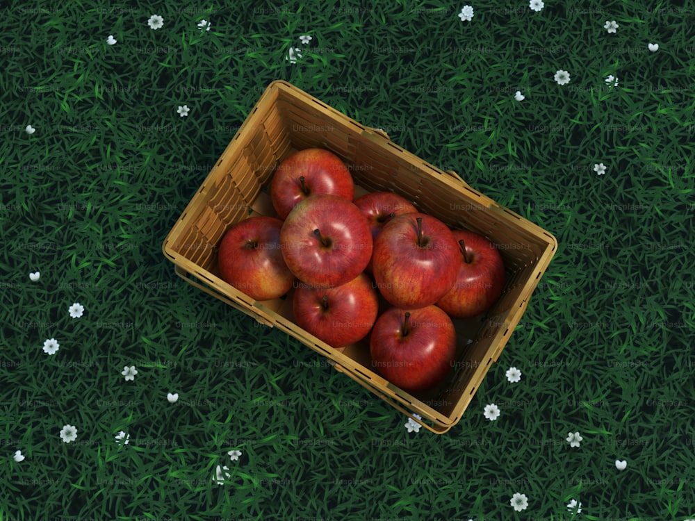 緑の野原の上に赤いリンゴが入った木箱