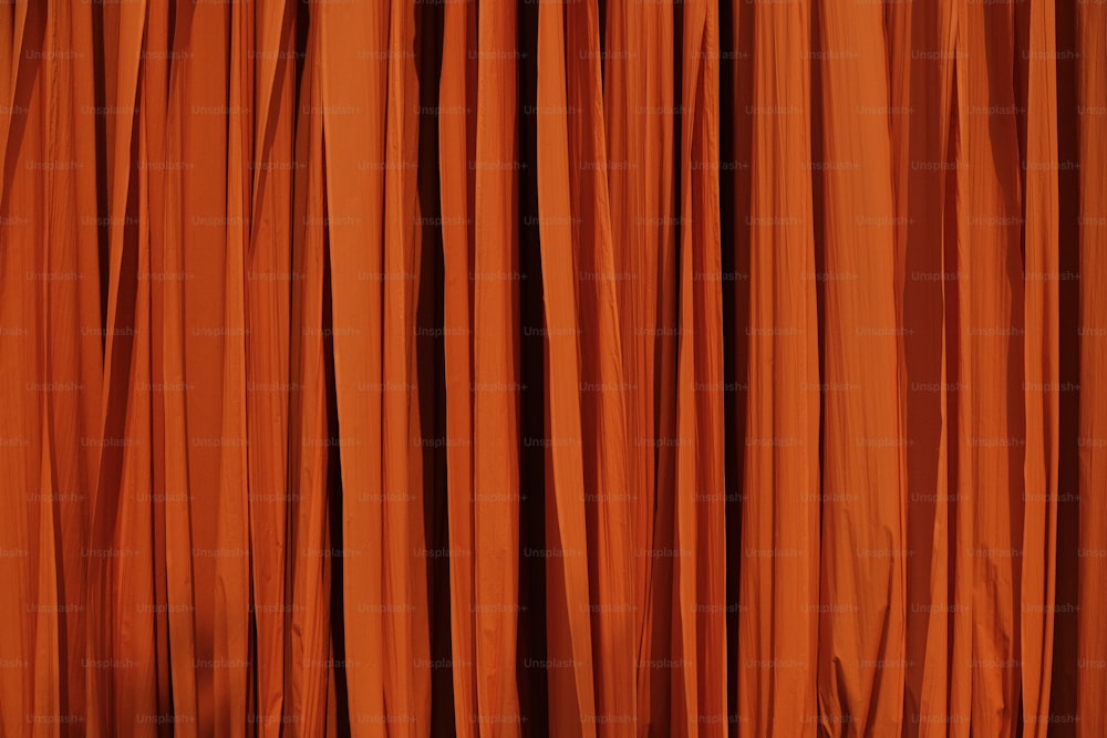 a close up of a curtain with orange curtains