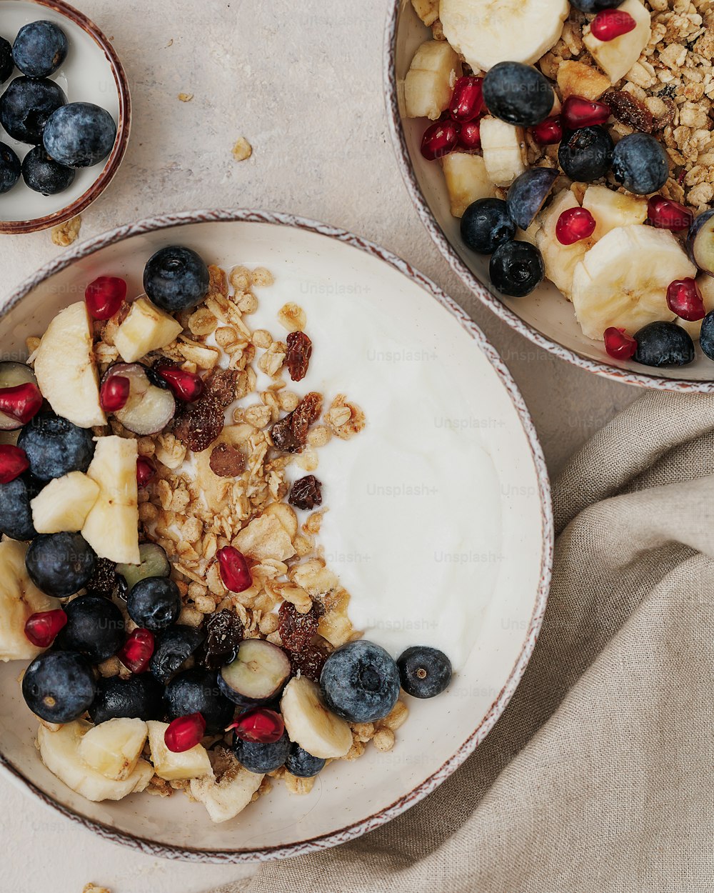 un tazón de granola y un tazón de fruta sobre una mesa