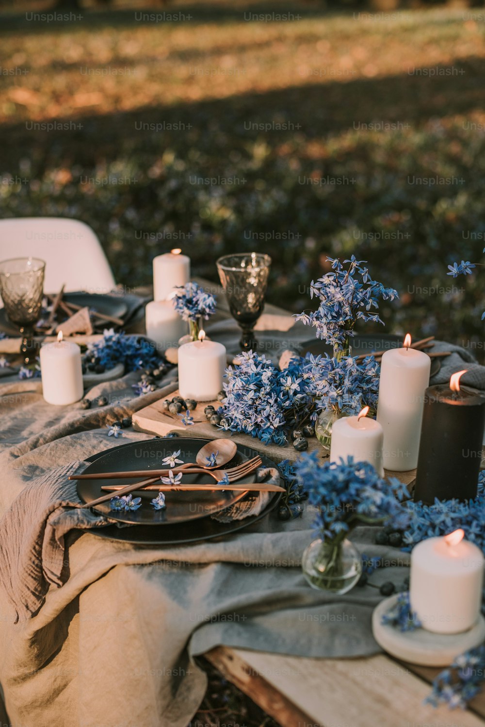 a table topped with lots of candles and flowers