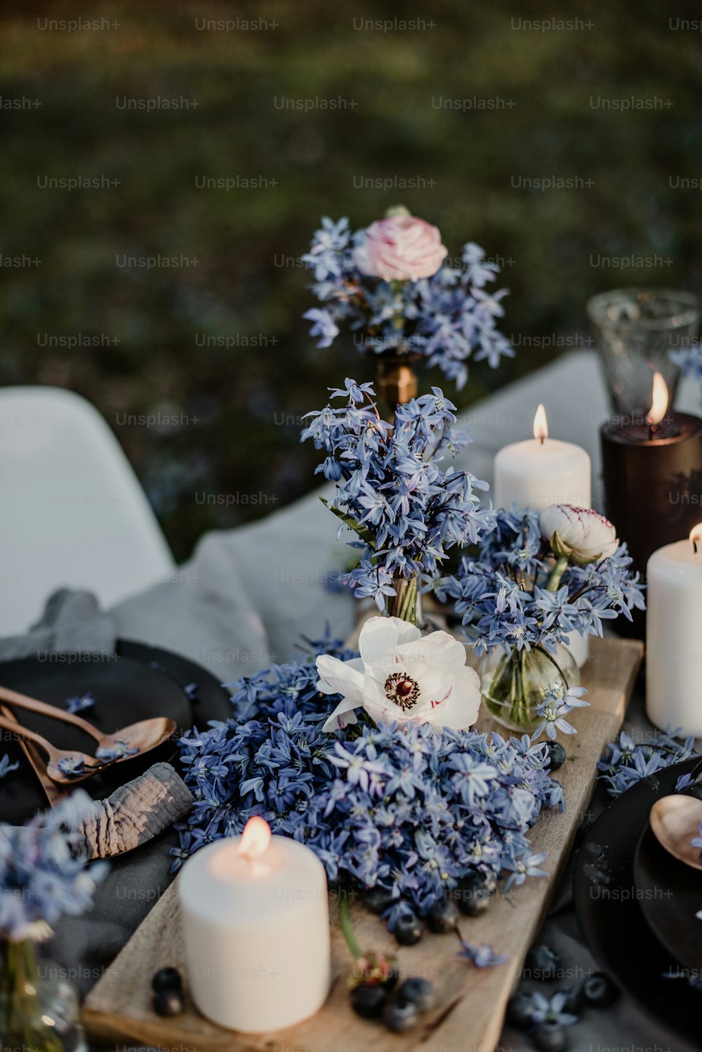 a table topped with candles and flowers on top of a table