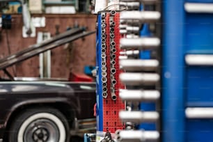 a car is parked in a garage with a bunch of tools attached to it