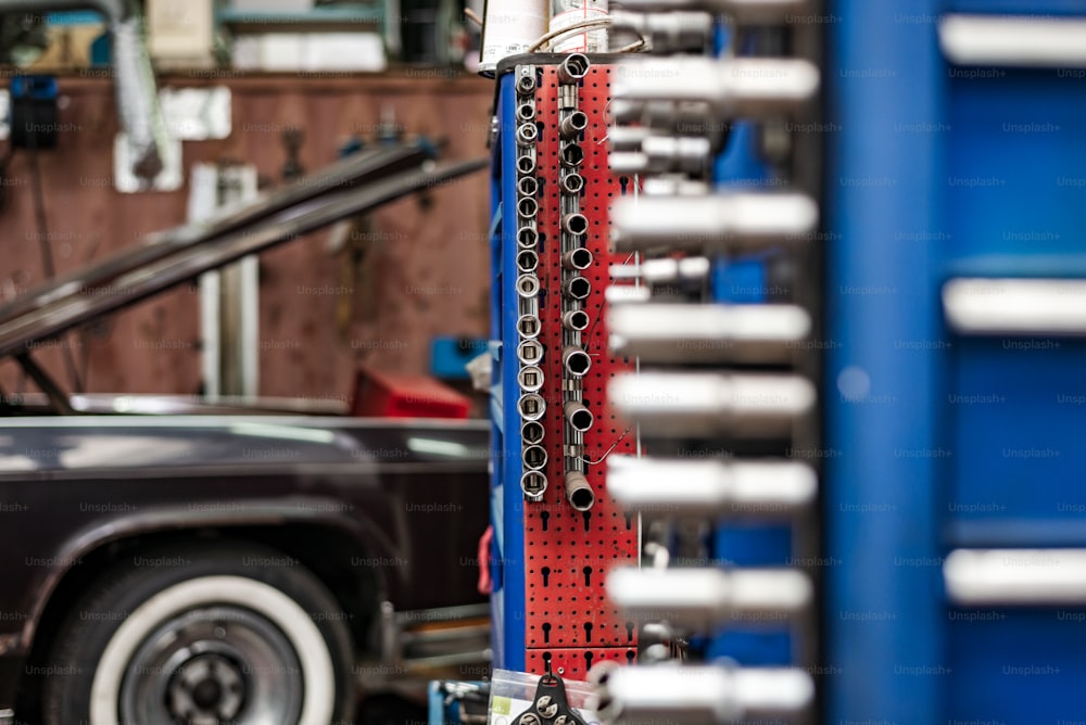 a car is parked in a garage with a bunch of tools attached to it