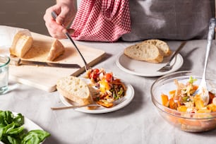 a person cutting bread on top of a table