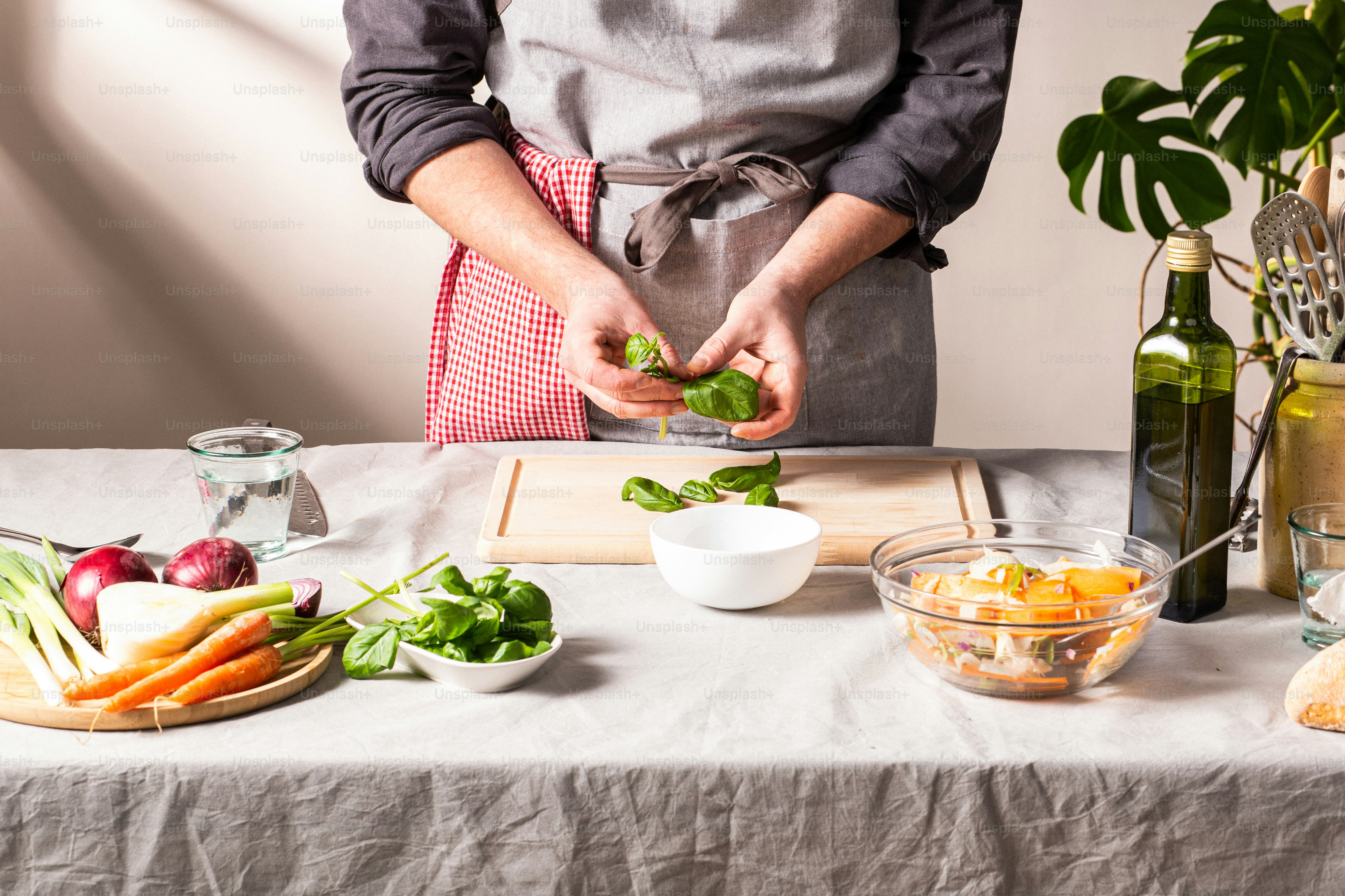 a person in an apron preparing food on a table