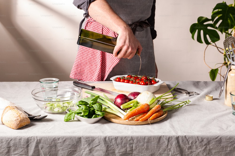 a person pouring wine into a bowl of vegetables