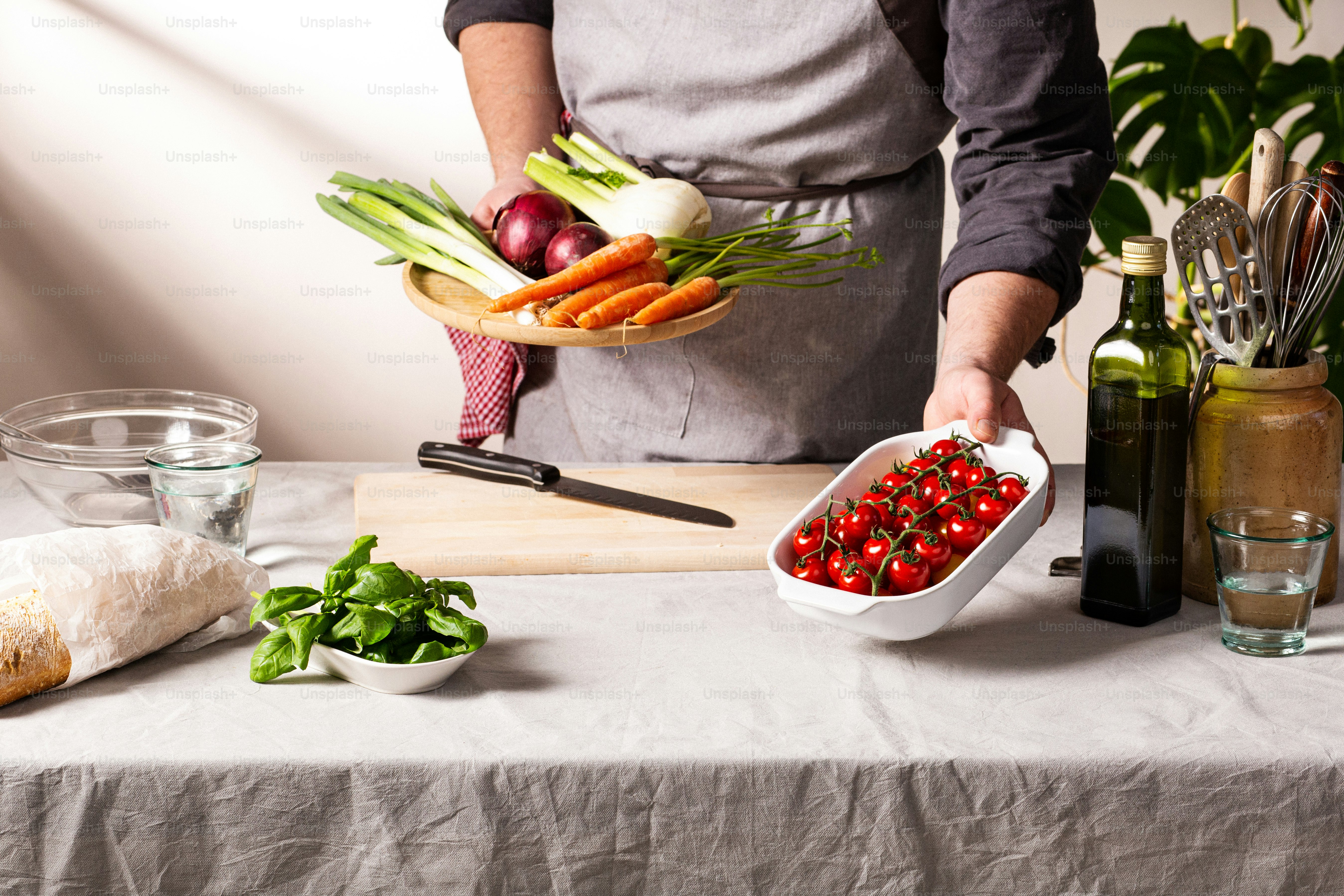 a person holding a bowl of vegetables on a table