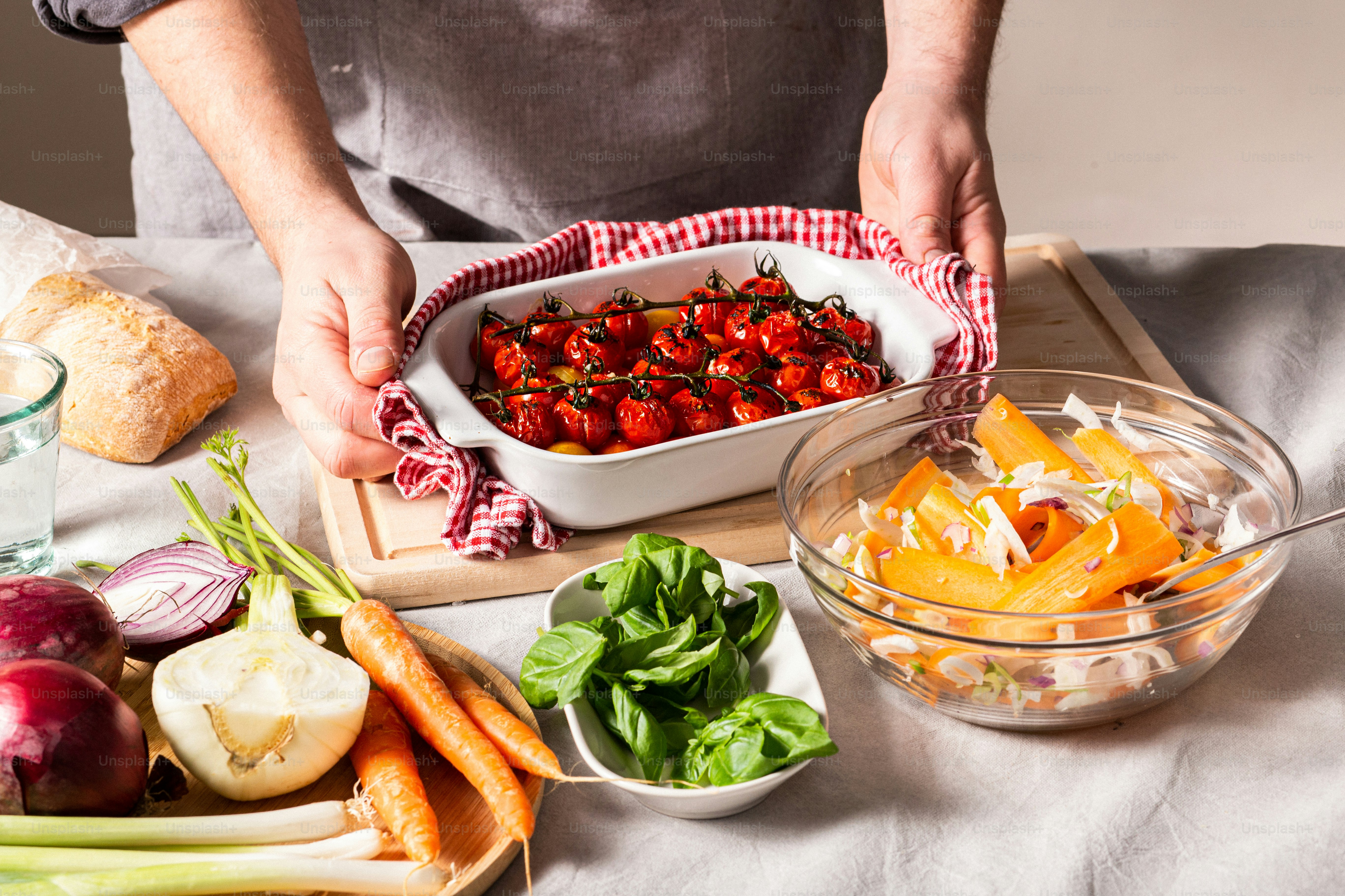 a person holding a bowl of fruit and vegetables