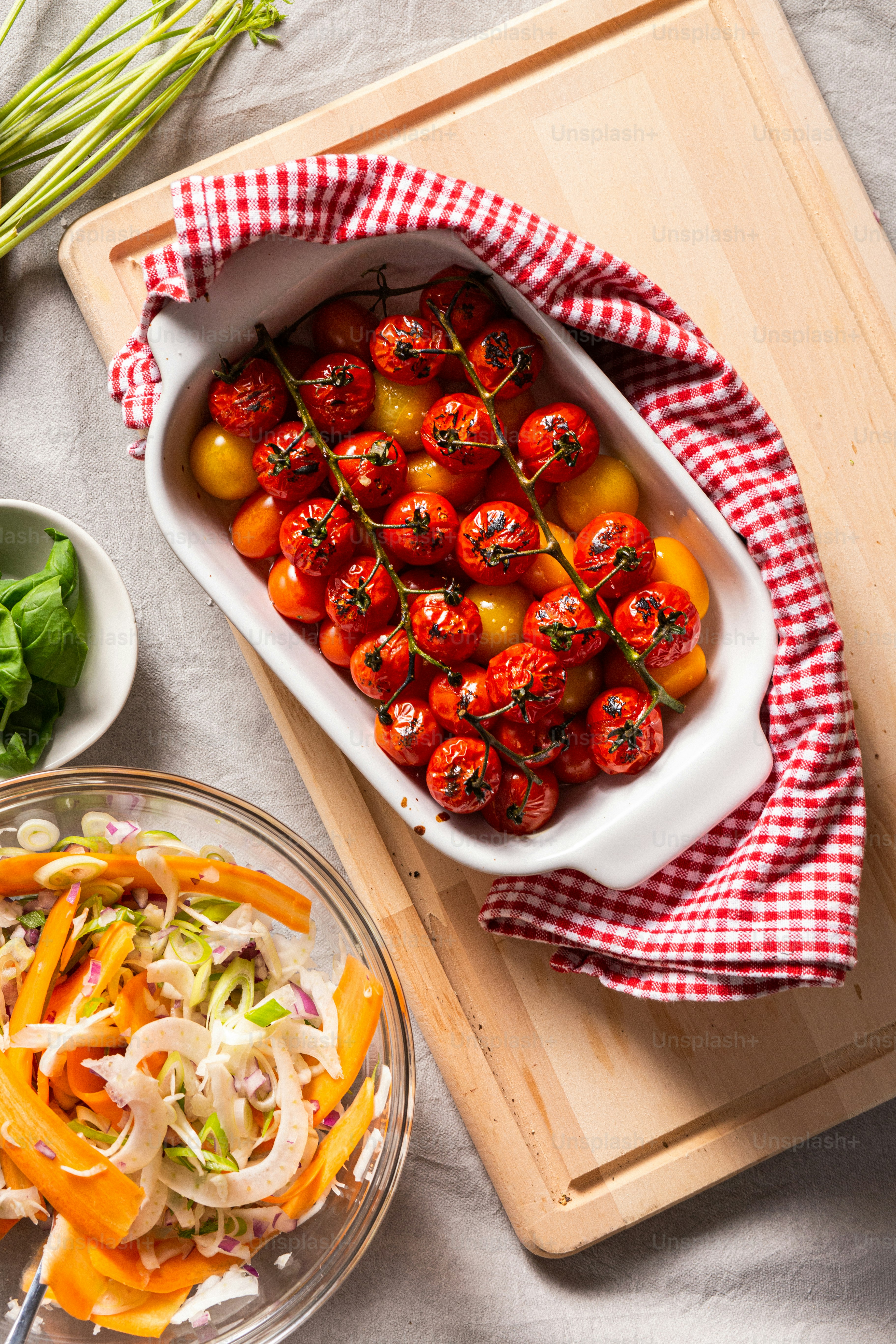 a tray of tomatoes and other vegetables on a table