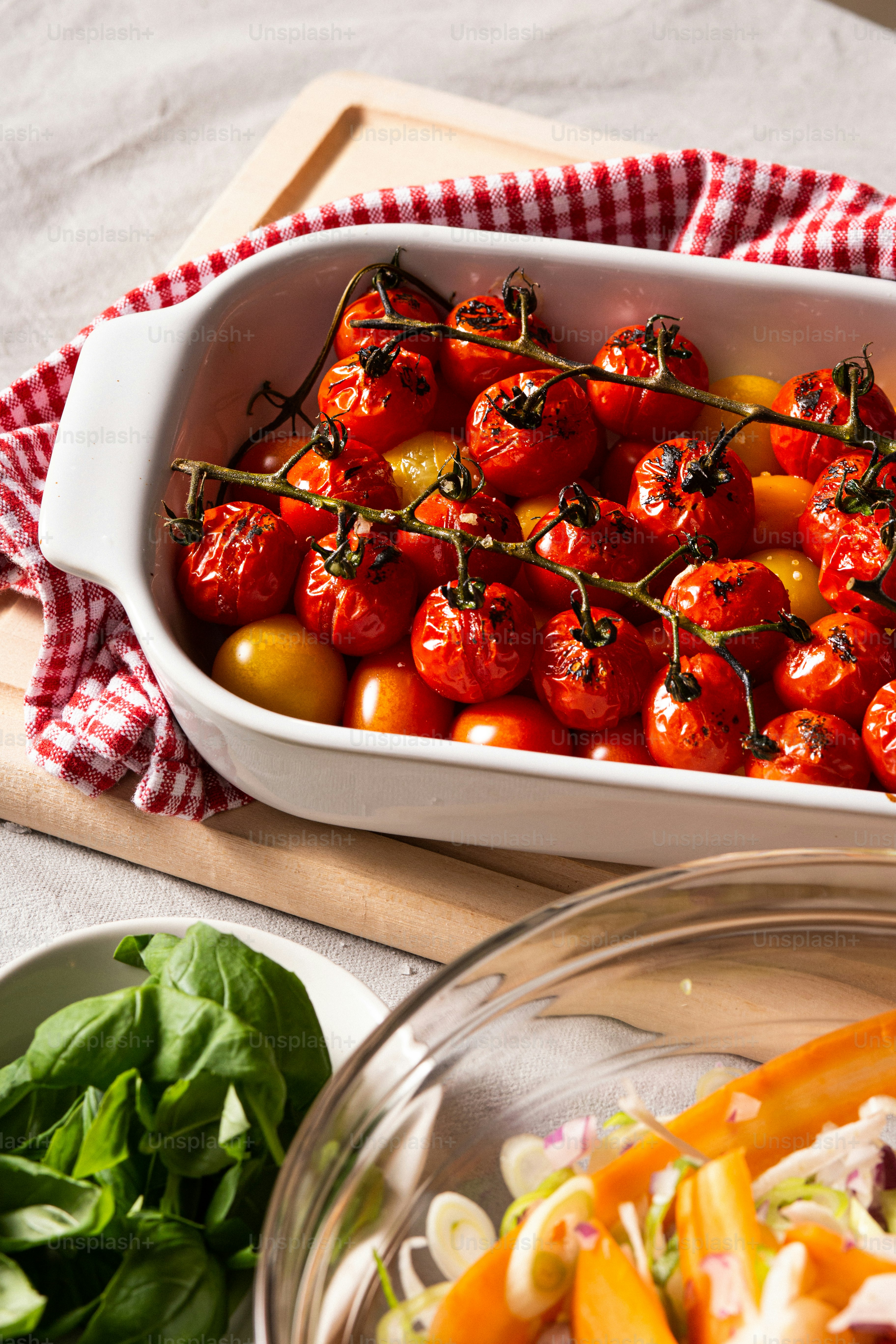 a casserole dish filled with tomatoes and other vegetables