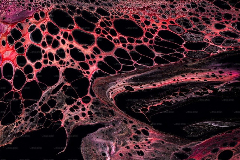 a close up view of a red and black substance