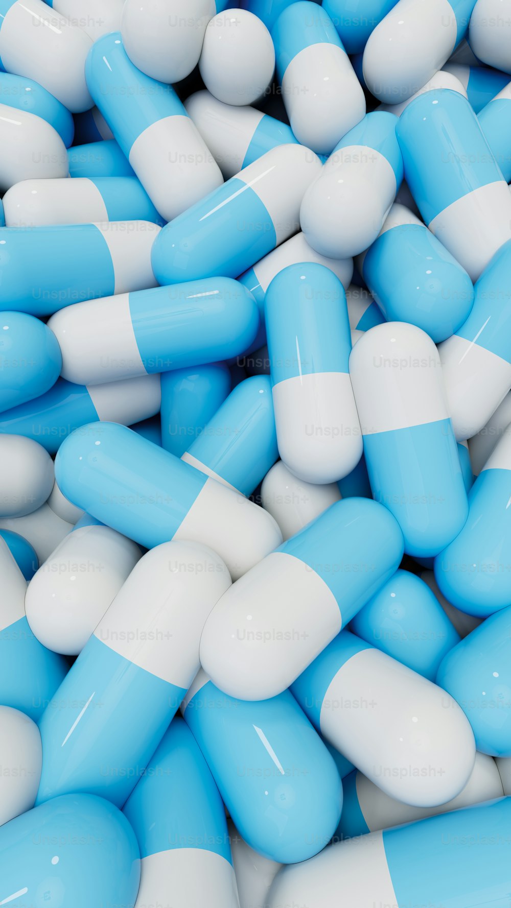a pile of blue and white pills sitting on top of each other