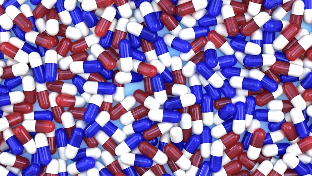 um monte de pílulas vermelhas, brancas e azuis