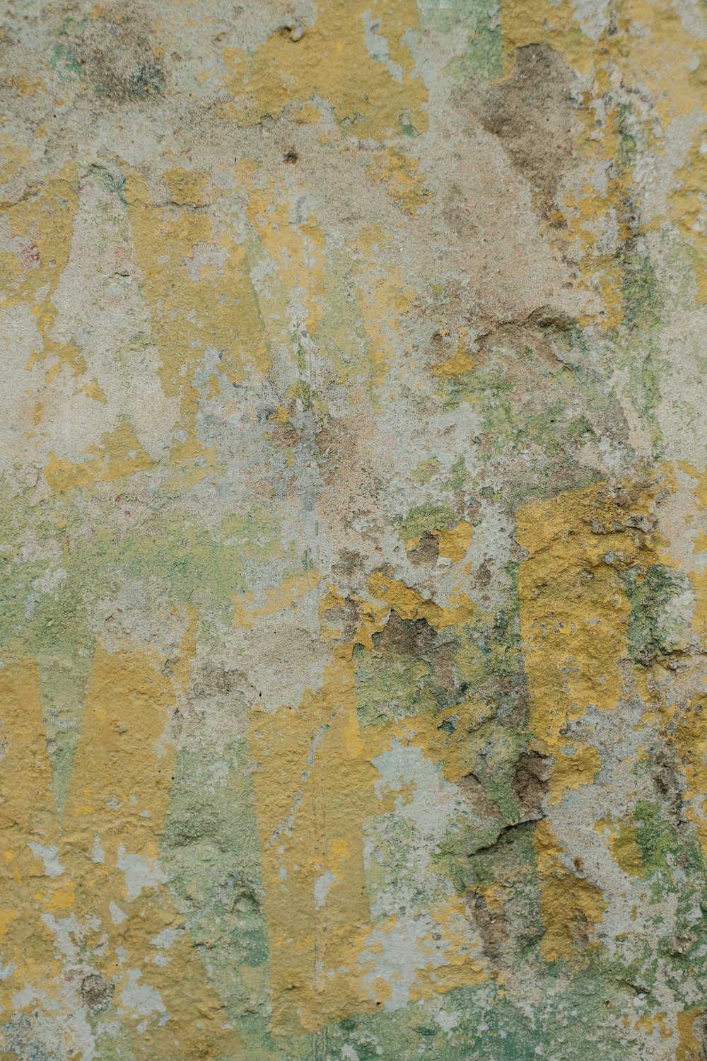 a close up of a wall with yellow and green paint