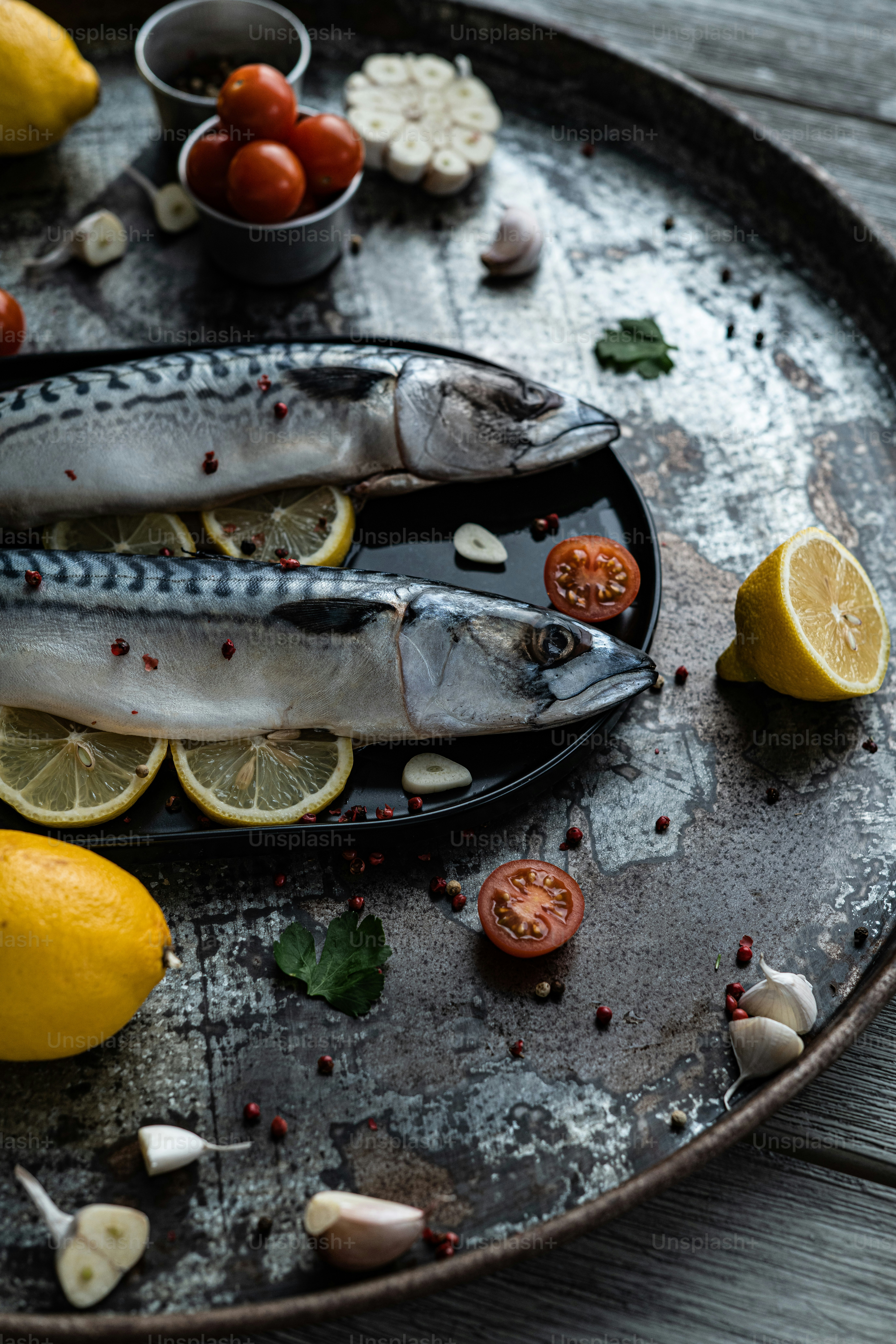 a couple of fish sitting on top of a metal tray