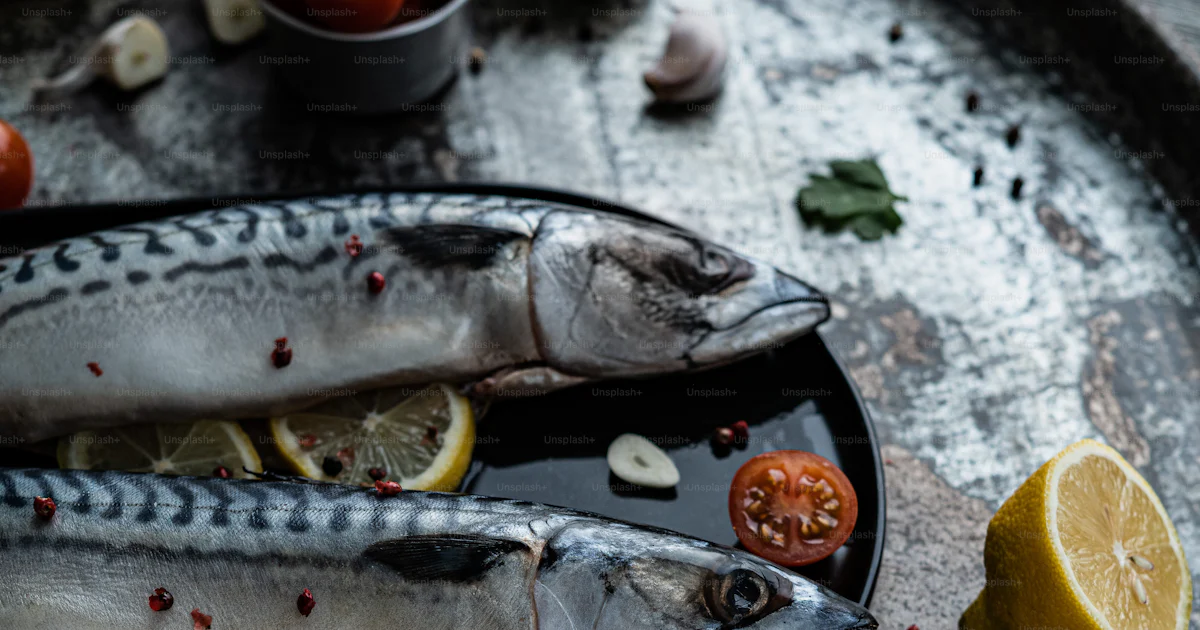 A couple of fish sitting on top of a metal tray photo – Prepared fish ...