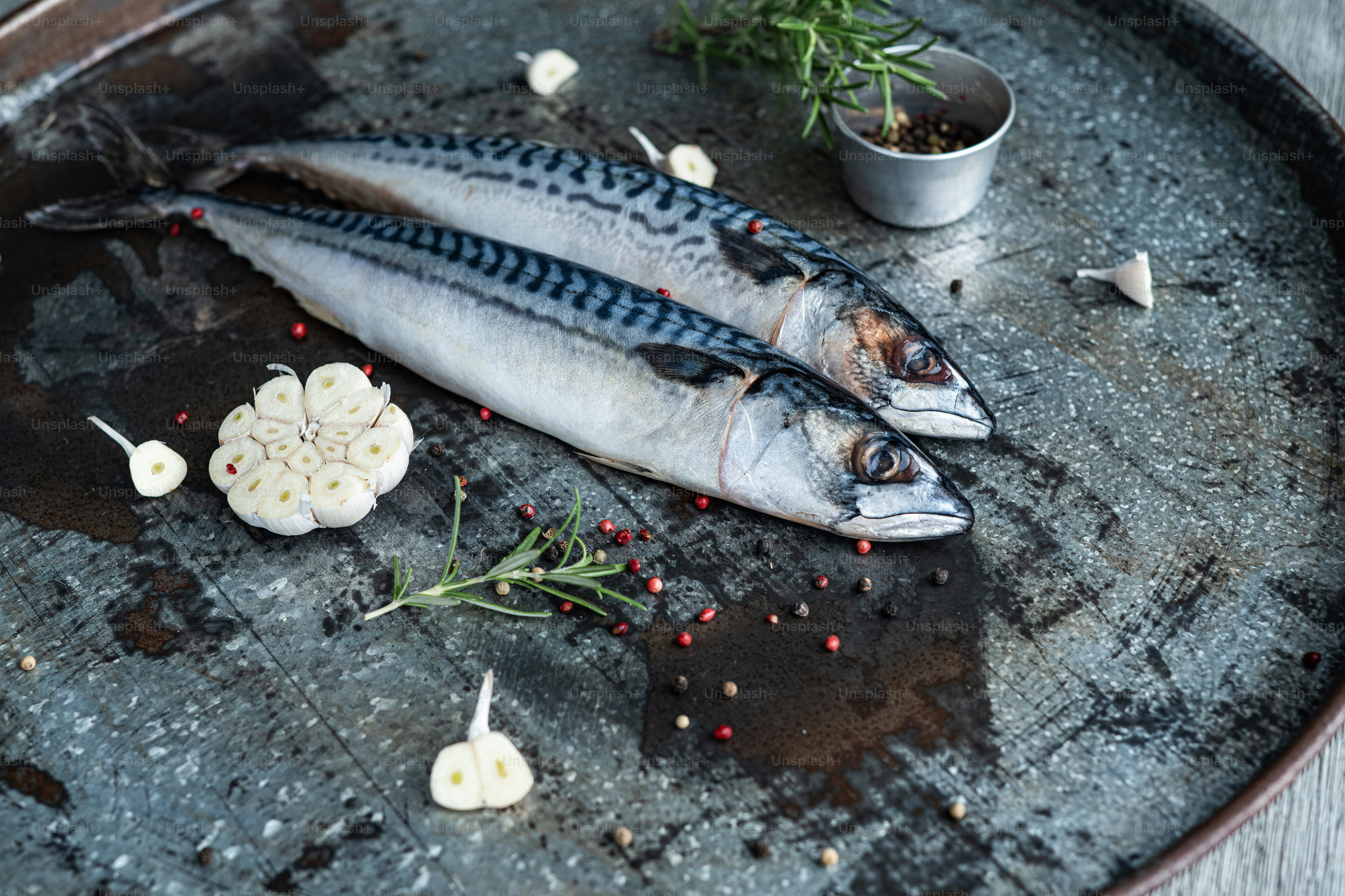 a couple of fish sitting on top of a metal pan