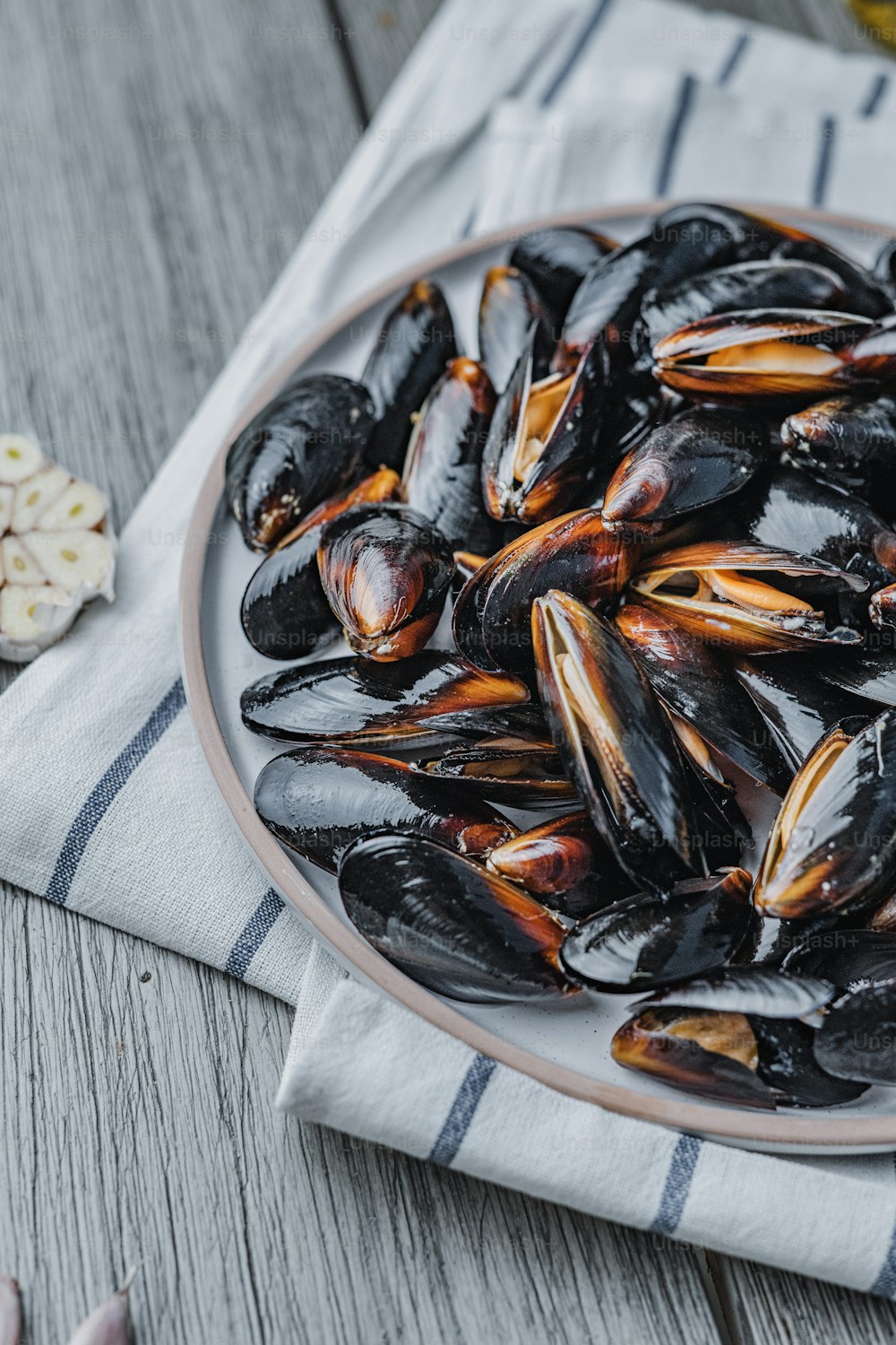 a plate full of mussels on a table