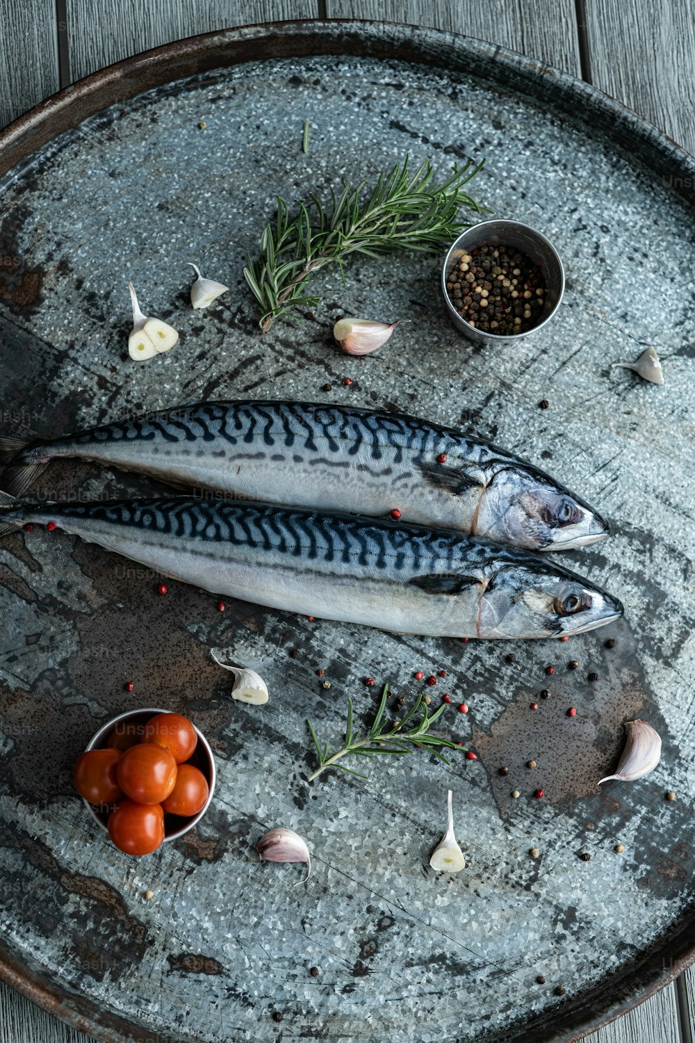 a couple of fish sitting on top of a metal tray