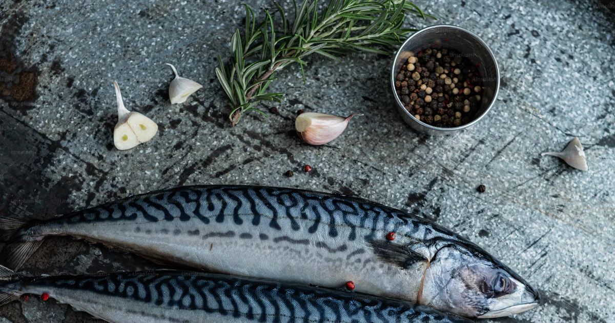 A couple of fish sitting on top of a metal tray photo – Prepared fish ...